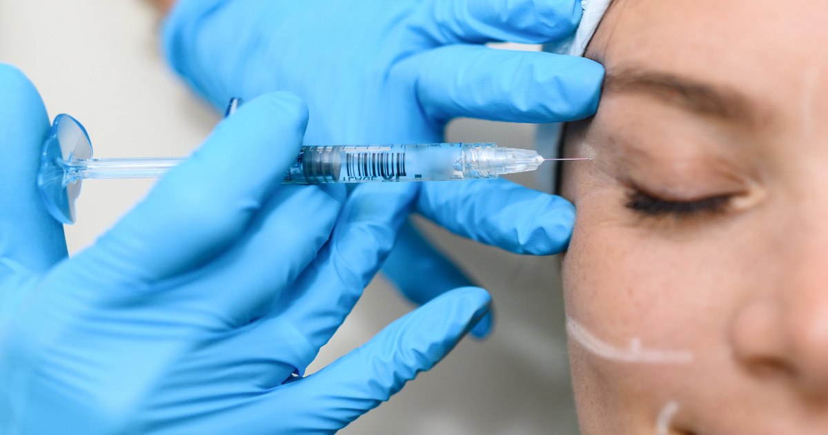 image of a woman getting botox by the eyes